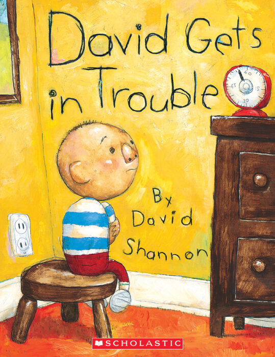 Main Character: A young boy named David with a round, bald head, a striped blue and white shirt, and red pants sitting on a small wooden stool facing a corner.Background: Bright yellow walls and a red floor. There is an electrical outlet on the wall to the left.Furniture & Objects: A dark brown wooden dresser is on the right with a red kitchen timer sitting on top of it.Logo: The Scholastic logo is featured in a red bar at the bottom center.